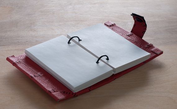 Open Red Notebook  on the  wooden background
