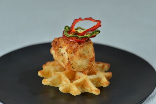 Image of a gourmet chicken and waffle appetizer