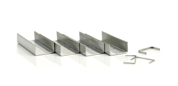 Stack of metal staples on a white background