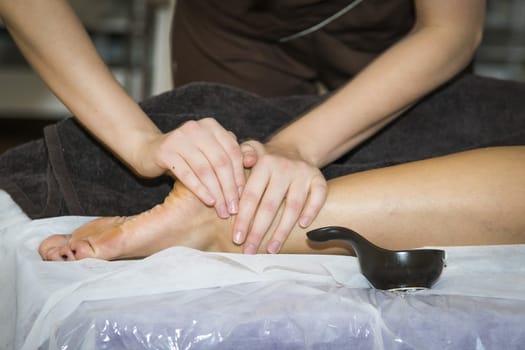 Massaging of young woman in SPA