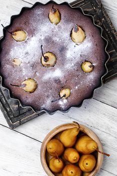 Baked sweet cake with whole pears in baking dish