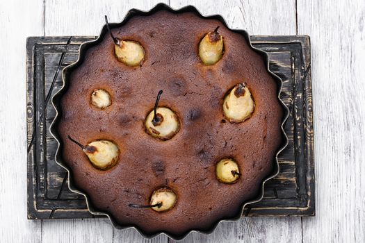 Baked sweet cake with whole pears in baking dish