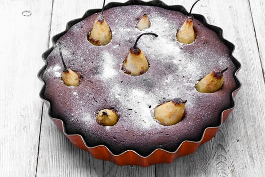 Baked sweet cake with whole pears in baking dish