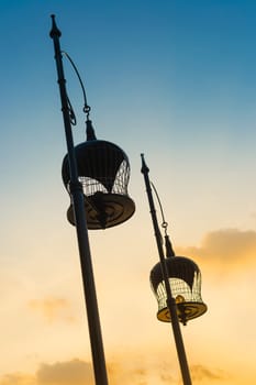 Two tone colors of sky with silhouette bird cages decoration.