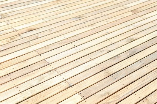 Unfinished new wooden floor at a construction site. Abstract background with copy space. Shallow depth of field. 