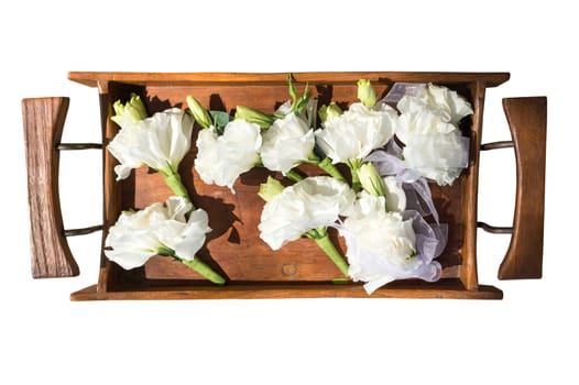 White flowers in a wooden tray, selective focus.