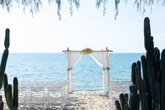 simple style wedding arch and decoration, venue, setup on tropical beach, outdoor beach wedding.