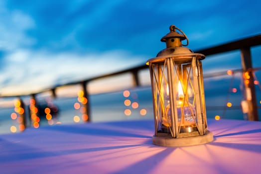 Lantern on table at twilight sky, selective focus.