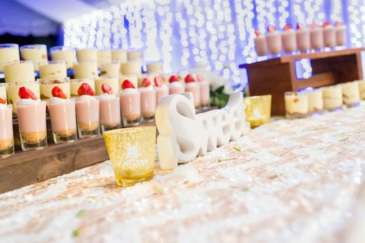 Sweet dessert on the buffet line with nice bokeh purple background, selective focus.