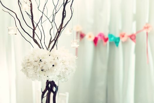 Vintage style ceremony decorations with a bouquet of white orchids and dry twigs