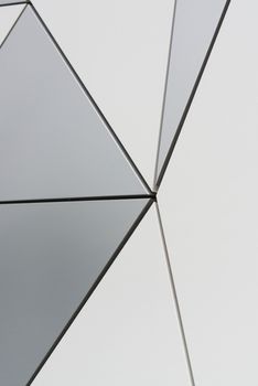 Wall of triangular composite panels, grey