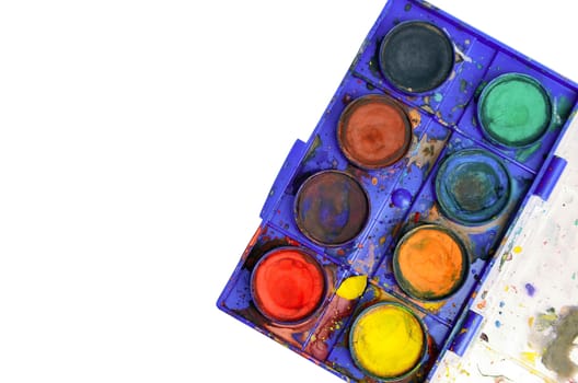 Top down view of old used watercolor box isolated on white. Copy space on left side.