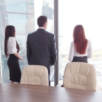 Rear view of business people looking at window