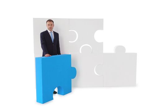 Portrait of business man and puzzle isolated on white background