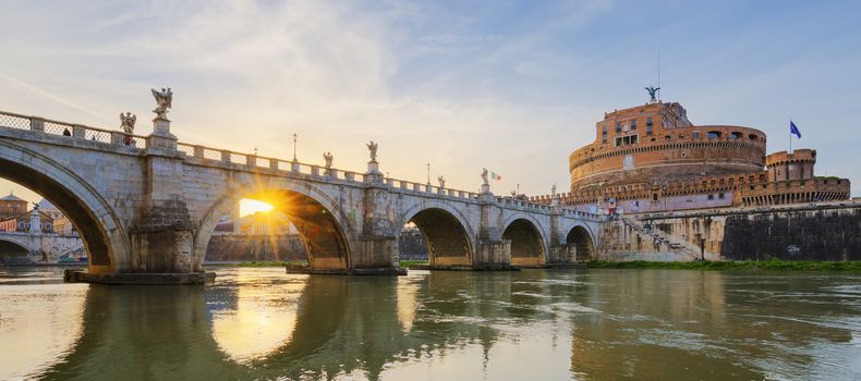 Castle of Holy Angel and Holy Angel Bridge over the Tiber River in Rome at sunset.