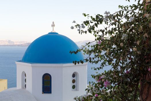 Blue domes and their bell tower in Oia. Santorini