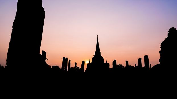 Silhouette for background, Ancient ruins and pagoda of Wat Phra Si Sanphet old temple famous attractions during sunset at Phra Nakhon Si Ayutthaya Historical Park, Thailand, 16:9 wide screen