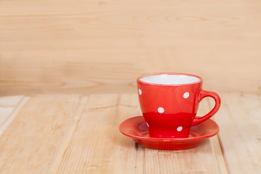 Red cup on wood background