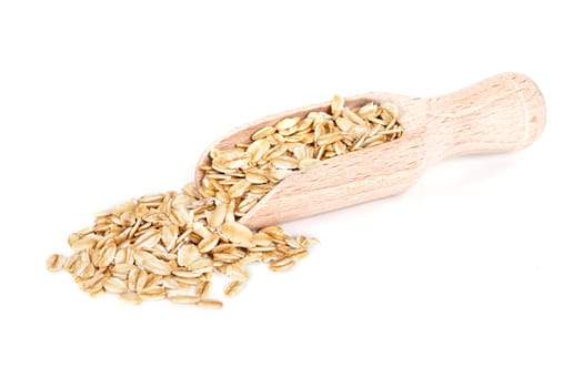 Oats flakes pile in wood spoon on white background