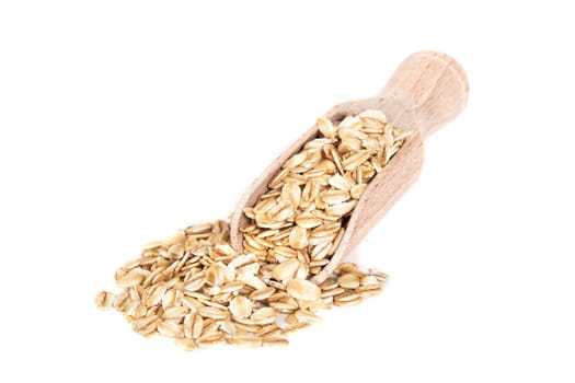 Oats flakes pile in wood spoon on white background