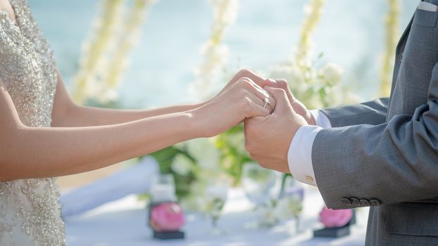 Man and Woman holding hands in wedding ceremony. Hand in hand.