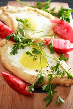 Geogrian traditional Khachapuri pastry with egg and cheese