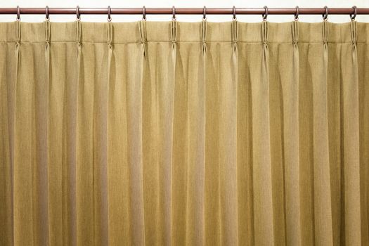 Brown curtains hang on the curtain rail.