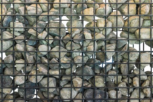 Gabion in close up, Black cage filled with rocks. Isolated.