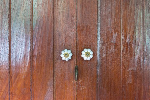 Close up Thai style wooden door with two handle.