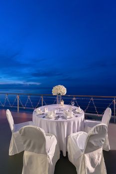 Romantic dinner setup, decoration with candle light. Selective focus. Twilight.