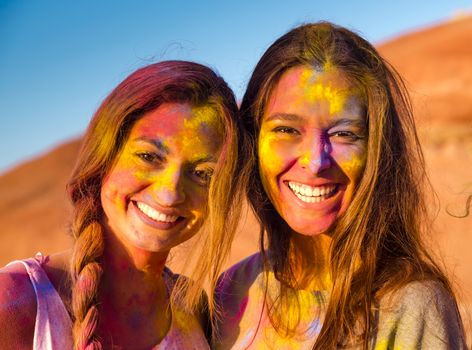 Best friends full of colored powder all over the body