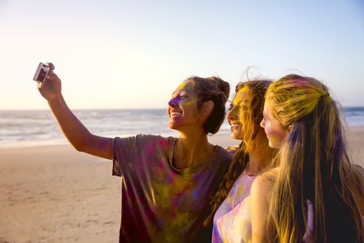 Teenagers making a selfie after playing with colored powder