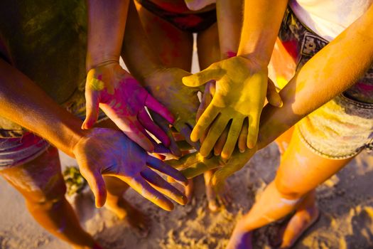 Teenagers playing with colored powder and showing her hands