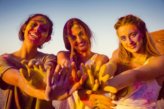 Teenagers playing with colored powder and showing her hands