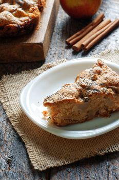 a slice of Apple pie on a wooden table