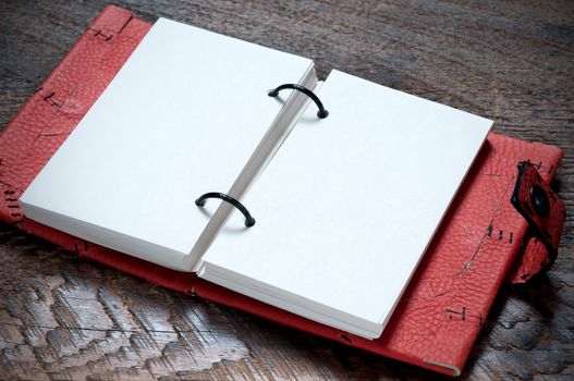 Open Red Notebook  on the wooden background