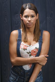 young woman wearing demin overalls and a sexy tank top