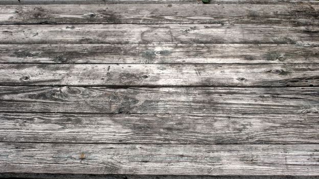 Vintage hipster wooden desktop top view, male hands using a laptop and holding a cup of coffee