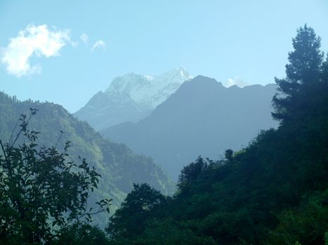 the Himalayan mountains with fog blue sky