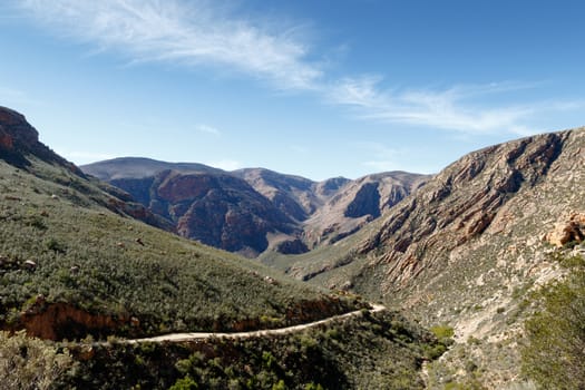 Leads to The Road - The Swartberg mountains are a mountain range in the Western Cape province of South Africa. It is composed of two main mountain chains running roughly east-west along the northern edge of the semi-arid Little Karoo.