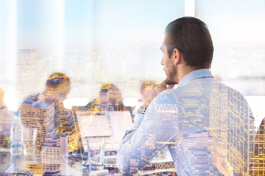 Business team meeting in conteporary corporate office. Businessman working on laptop computer. New Your city lights reflection in window. Business success concept.
