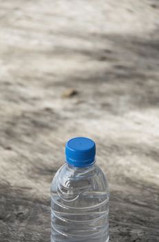 Plastic water bottle on wooden table texture. Fresh concept.