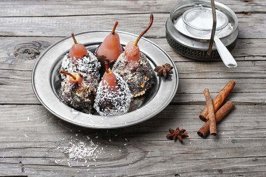 Dessert of pears with chocolate syrup and coconut flakes