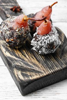 Dessert of pears with chocolate syrup and coconut flakes