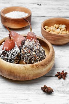 Dessert of pears with chocolate syrup and coconut flakes