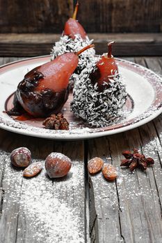 Dessert of pears with chocolate syrup and coconut flakes