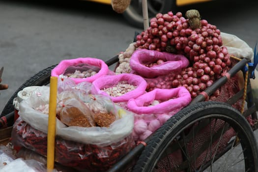 Onion, Garlic, Chilly and Peppers in push cart at the market