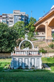 Ancient fountain in the middle of italian city