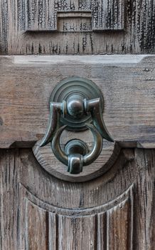 Closeup of ancient door with metallic clapper