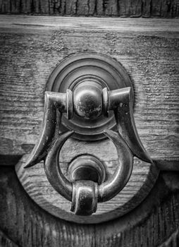 Closeup of ancient door with metallic clapper